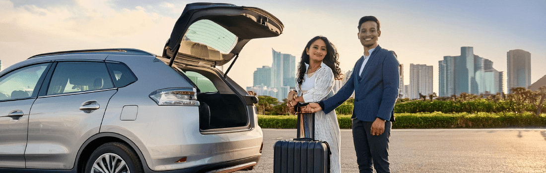 A family arriving at the airport, happy with their rental car from Fox Rent A Car, after booking early to save money and avoid last-minute stress.